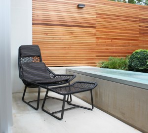 Garden Design in Chelsea SW3 - seating area, bespoke Corten-Steel panel, rustic slate feature wall, bespoke pedestals, designed furnitures, bespoke barbecue unit, planting design chelsea, ferns, box balls